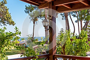 View of the tropical garden and the sea on a sunny day from the hotel veranda