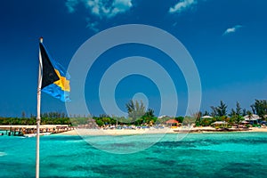 View on the tropical island in Bahamas with the national Bahama flag.