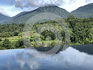 View of the tropical nature and mountains and the pool in the foreground. Baturiti Tabanan, Bali