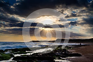 View of tropical rocky beach landscape at sunrise