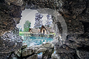 View trough a cave hole to the old straw houses in bally park sc photo