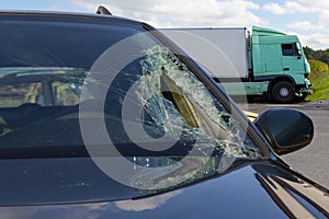 View of truck in an accident with car, broken glass