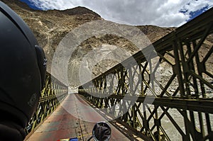 A view of a Truss bridge on the way to Hunder region of Ladakh with Himalayan ranges in the background.