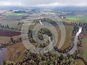 View at Tualatin river from above. Scenic view of a farming fields and trees on sides of a river