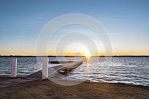 View of Tuggerah Lake in Toukley, Central Coast, NSW, Australia at sunset, with a jetty jutting out photo