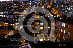 View of turkish residential buildings with illuminated windows at night