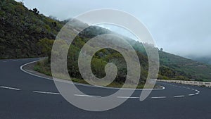 View of the turn of a mountain road at cloud level