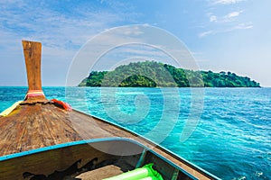 View on turquoise clear water and traditional wooden boat in Bamboo island, Phi Phi, Thailand