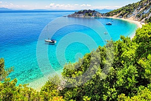 View of turquoise sea with boats and Gidaki beach on Ithaca island