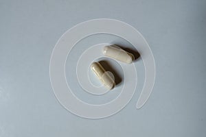 View of two beige capsules of Saccharomyces boulardii probiotic from above