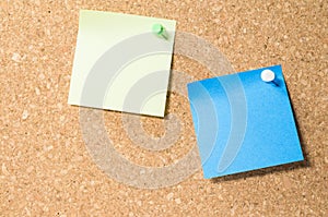 View of two blank post-it notes on a corkboard with copy space