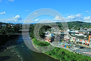 View of two bridges and the river napo that slices through Tena, Ecuador photo