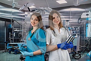 view of two female surgeons preparing for surgery in the operating room.