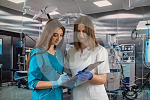 view of two female surgeons preparing for surgery in the operating room.