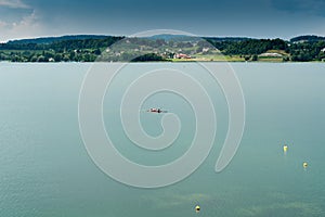 View of two male athletes rowing and training on a lake