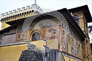 View of two sides, both richly decorated and of the crenellated tower of the ancient and beautiful villa Stibbert in Florence.