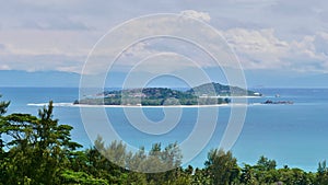 View of the two tiny islands Cousin and Cousine from the north of Praslin island, Seychelles.