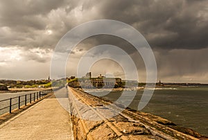 The view of Tynemouth Priory taken from Tynemouth`s North Pier on a rainy summer`s day photo