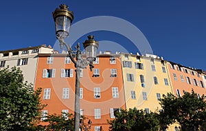 A view of typical Bastia lamppost and colorful houses , Corsica island, France .