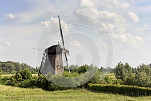 View on a typical historical windmill in a dutch landscape.