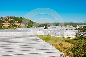 View of a typical landscape with large greenhouses for growing fruits and vegetables, in particular bananas. Agro-industrial