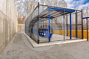 View of typical nondescript high school softball clay infield from behind the first base dugout