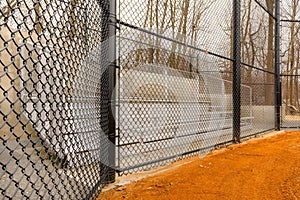 View of typical nondescript high school softball field aluminum bleachers