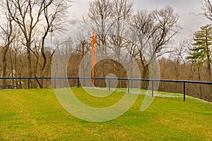 View of typical nondescript high school softball left outfield orange foul pole