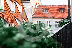 A view of typical Prague house with red tile roof. Balcony