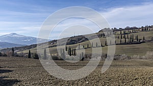 View of the typical Sienese countryside with Mount Amiata covered in snow in the background, Tuscany, Italy