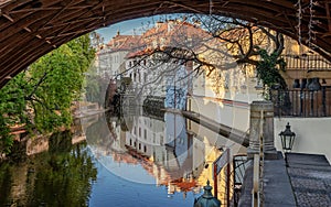 View under the arch of the Charles Bridge on the Certovka water wheel. Prague.