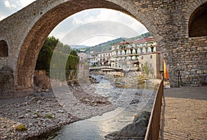 View under the bridge of river houses in Camprodon. photo