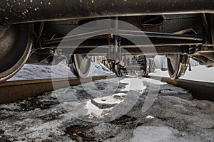 View under the train car. It looks like a freight train from below