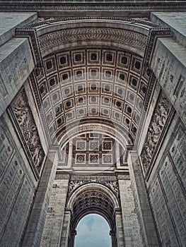 View underneath triumphal Arch Arc de triomphe in Paris, France. Architectural details of the famous historic landmark