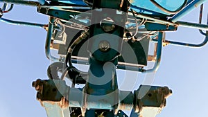 View from underneath of worker on cherry picker