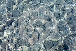 View of underwater pebbles in the sea, pebble background