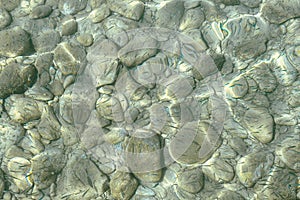 View of underwater pebbles in the sea, pebble background