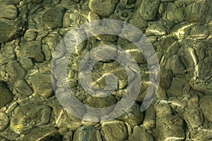 View of underwater pebbles in the sea, pebble background