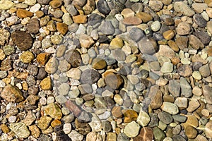 View of underwater pebbles in the sea, pebble background