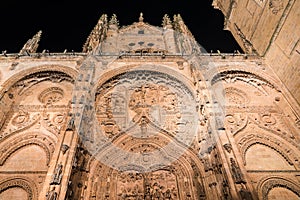 View of the University of Salamanca illuminated at night. Low angle view of Plateresque main facade