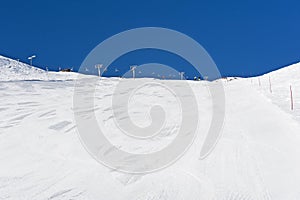 View up a piste in alpine ski resort