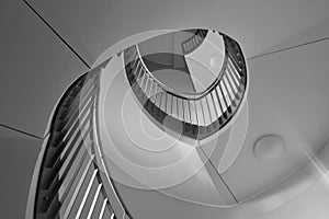 View up the spiral staircase. Black and white photo.