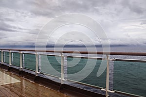 View from upper deck of modern cruise ship on a wet grey stormy day in the Tropics