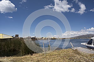 View of Uros floating islands with typical boats, Puno, Peru