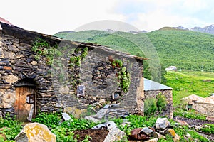 View of the Ushguli village at the foot of Mt. Shkhara. Lamaria Monastery, Rock tower towers and old houses in Ushguli