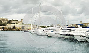 View of Valletta`s Fort St Elmo and yachts moored at Msida Marina