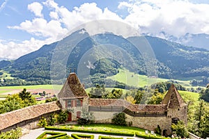 View of the valley, alpine mountains and cloudy sky from Castle Gruyeres, Switzerland