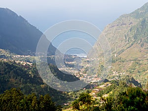 View of a valley in Madeira island, Portugal, with the Atlantic Ocean in the background