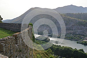 View of a valley with a rural settlement from the ancient stone wall of Rozafa Castle in Shkoder, Albania