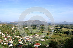 View of a valley with a rural settlement from the ancient stone wall of Rozafa Castle in Shkoder, Albania